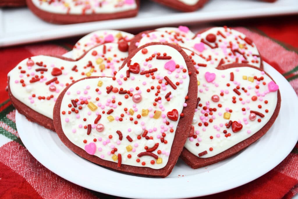close up of Heart-Shaped Red Velvet Cookies on a round white plate