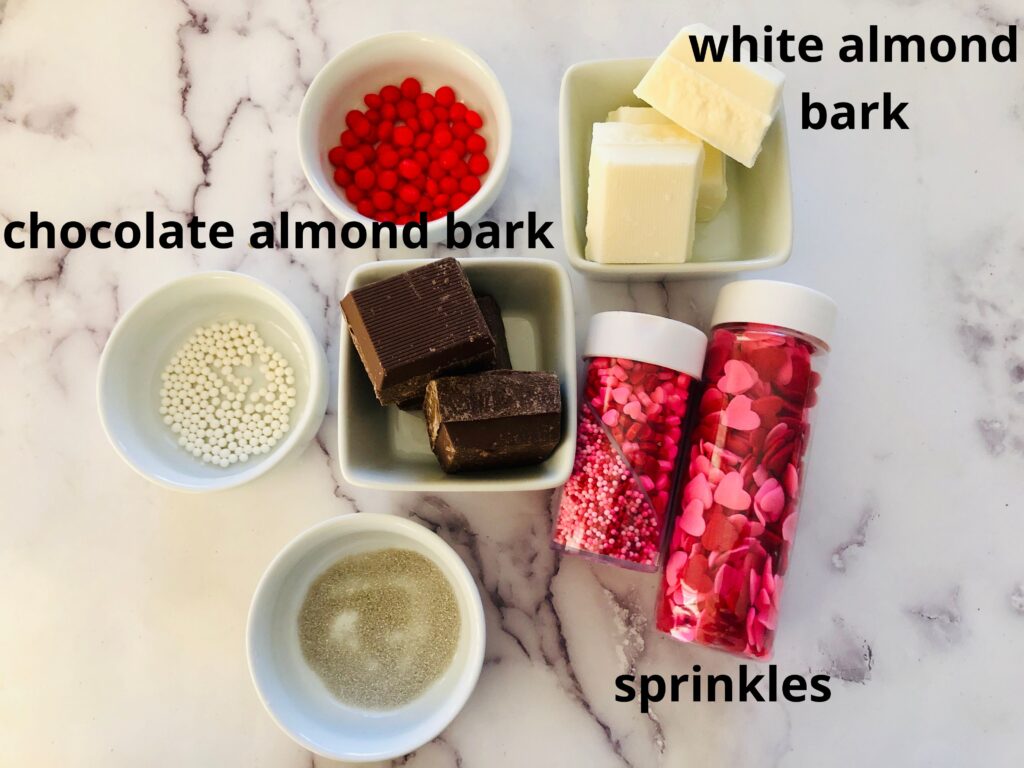 ingredients for valentine's day bark on a marble counter