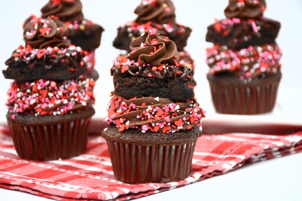 five Valentine's Day Chocolate Brownie Cupcakes on a red and white napkin