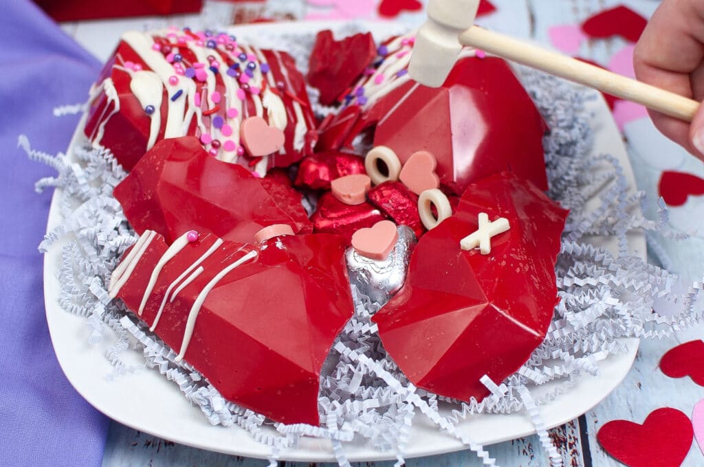 smashed open red breakable heart filled with chocolate