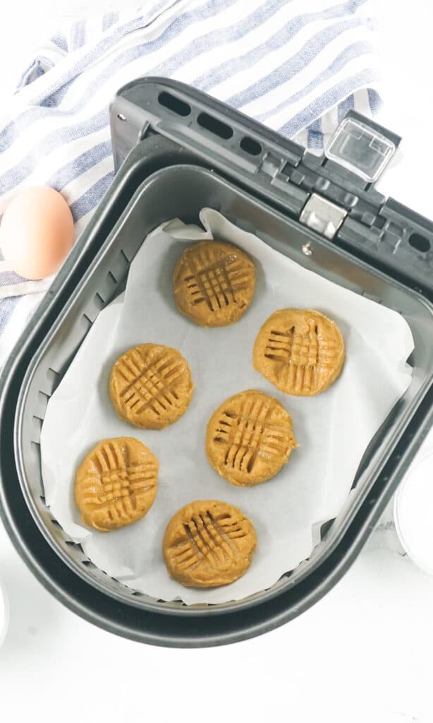 peanut butter cookies in a parchment paper lined air fryer