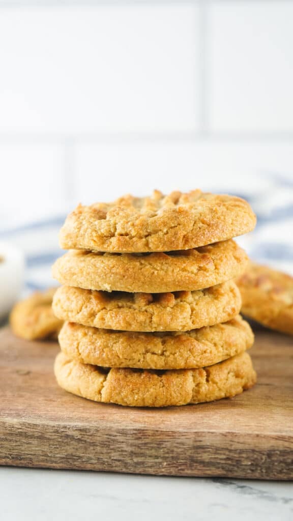 close up of a stack of air fryer peanut butter cookies on a wooden cutting board