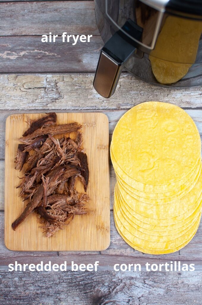 ingredients for air fryer beef taquitos on a wooden background