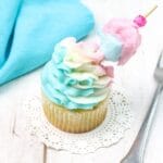square image of a single cotton candy cupcake on a wooden background
