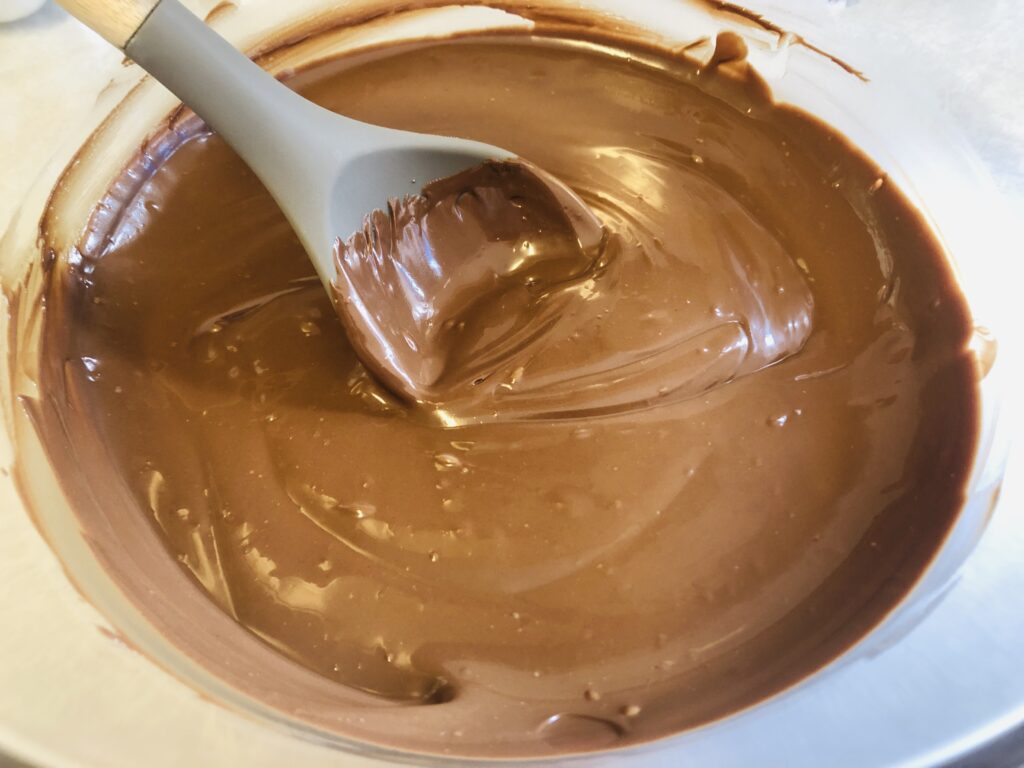 semi sweet chocolate chips being melted in a glass bowl