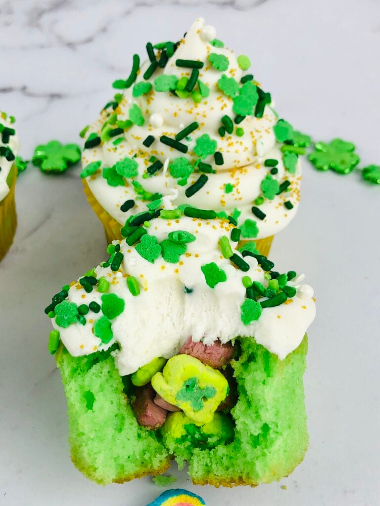 Lucky Charms Cupcake broken up to show the cereal inside. 