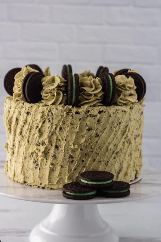 Vertical image of an off center Oreo Mint Cake on a cake pedestal