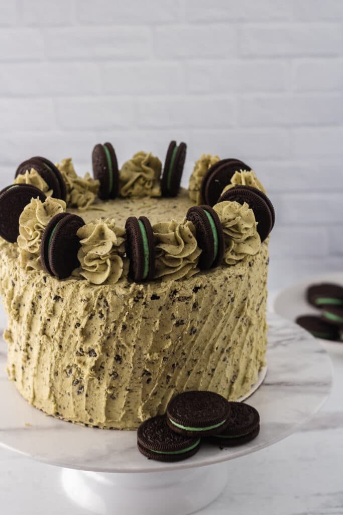 Off center image of an Oreo Mint Cake on a cake stand