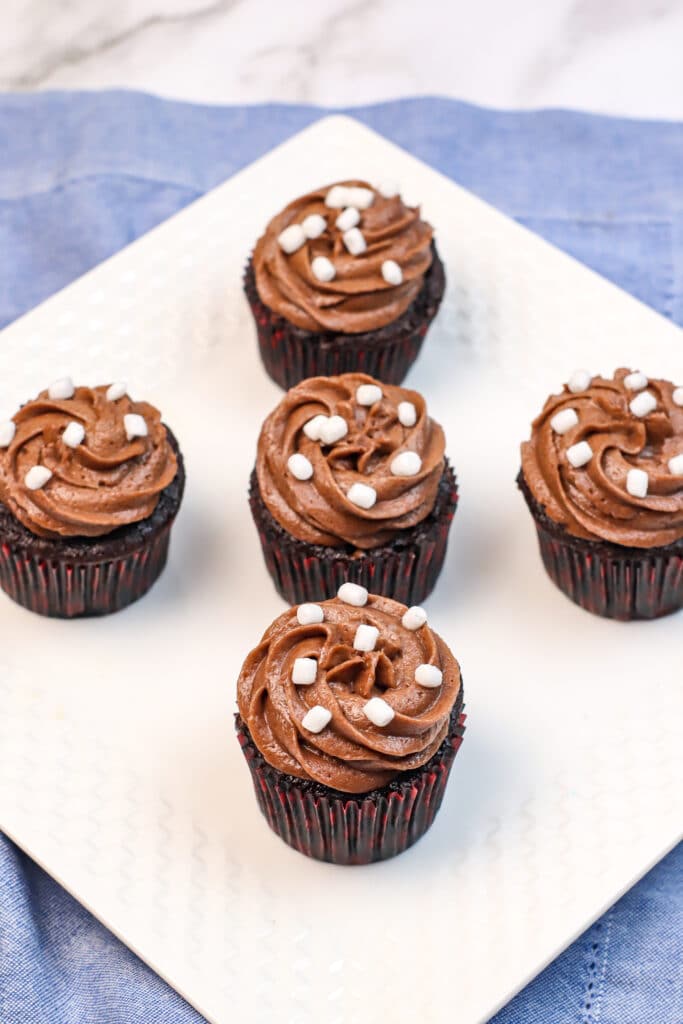 five hot cocoa cupcakes on a white plates