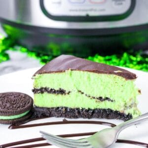 square image size for recipe card of a slice of green cheesecake on white plate with a fork and mint oreo next to it