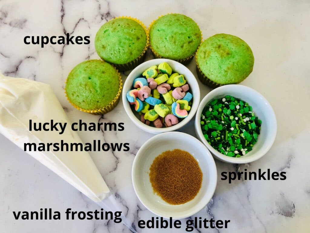 ingredients of lucky charms cupcakes labeled with text on a marble counter
