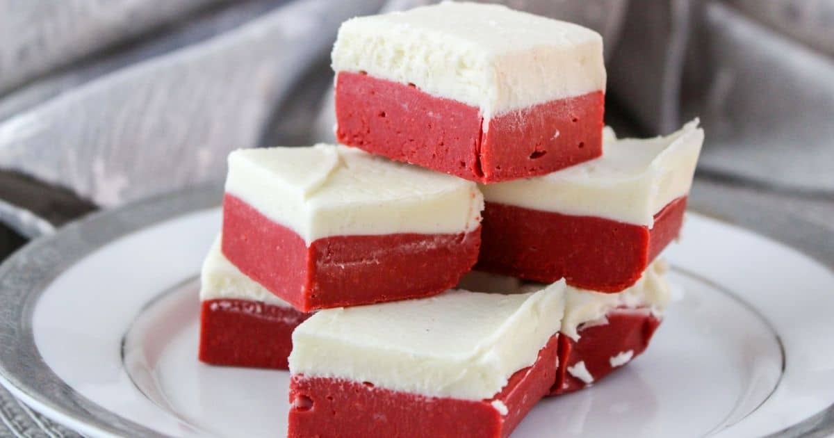 rectangle image of a plate of red velvet fudge topped with a cream cheese layer