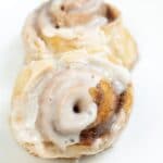square image sized for recipe card with close up image of sourdough discard cinnamon rolls on a white plate