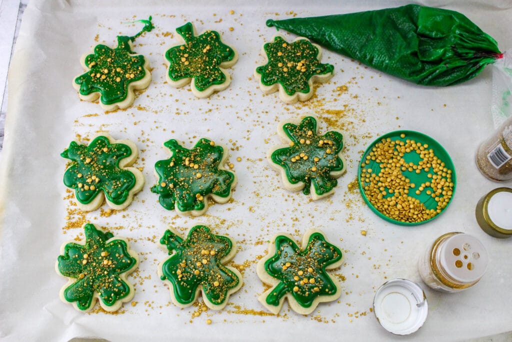 decorated st. patrick's day cookies on a parchment lined baking sheet