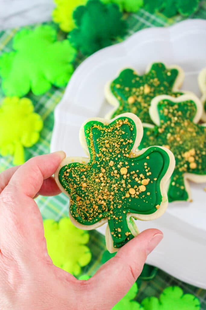 close up of a st. patrick's day cookie in a woman's hand