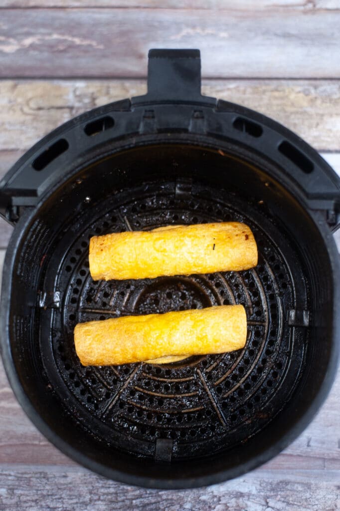 cooked beef Taquitos in an air fryer basket