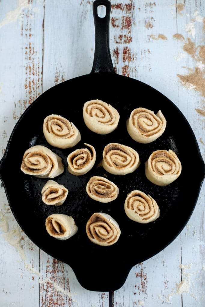 cinnamon rolls placed in an a cast-iron skillet