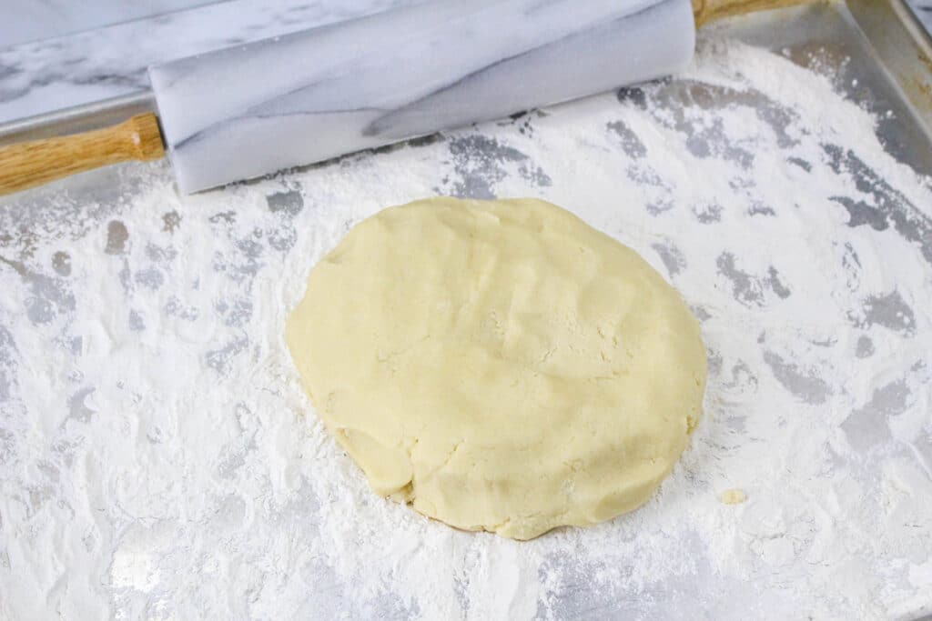 sugar cookie dough on a powdered sugar surface