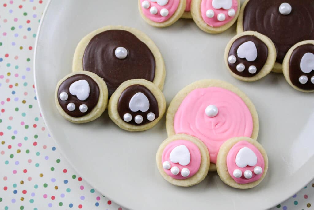 close up of a pink and brown bunny butt cookies on a white plate