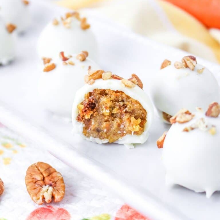 square image of a carrot cake truffle bit in half on a white platter