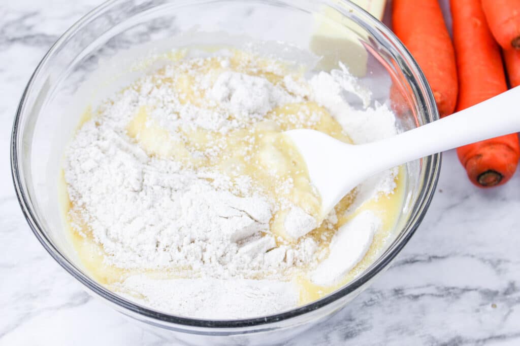 carrot cake batter in a glass mixing bowl