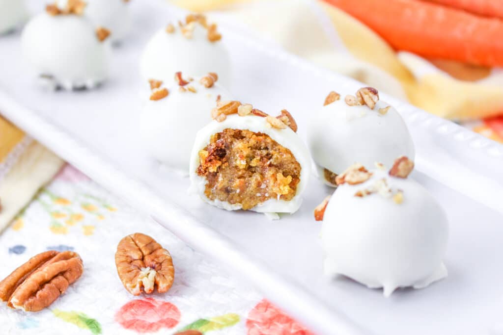 close up of the inside of a carrot cake truffle on a a white platter