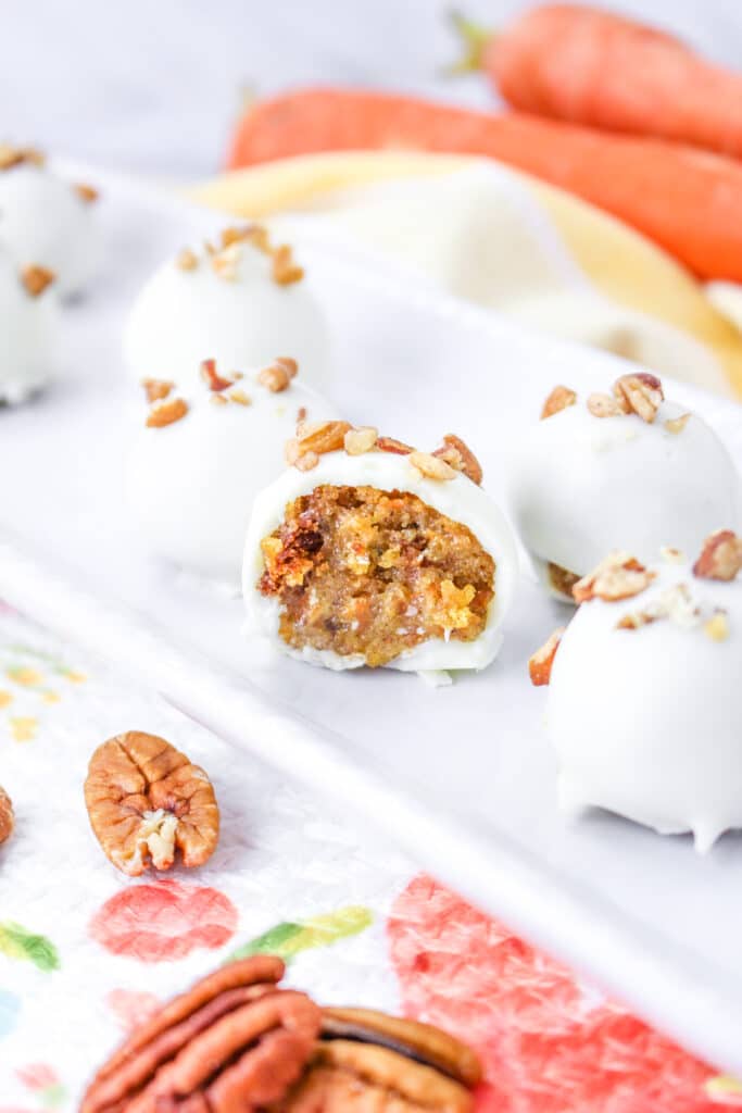 vertical image of the inside of a carrot cake truffle on a white platter
