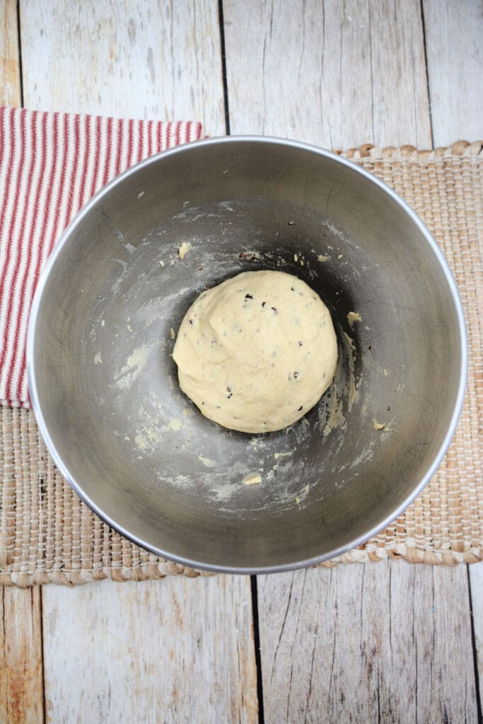 chocolate chip cookie dough in a stainless steel mixing bowl