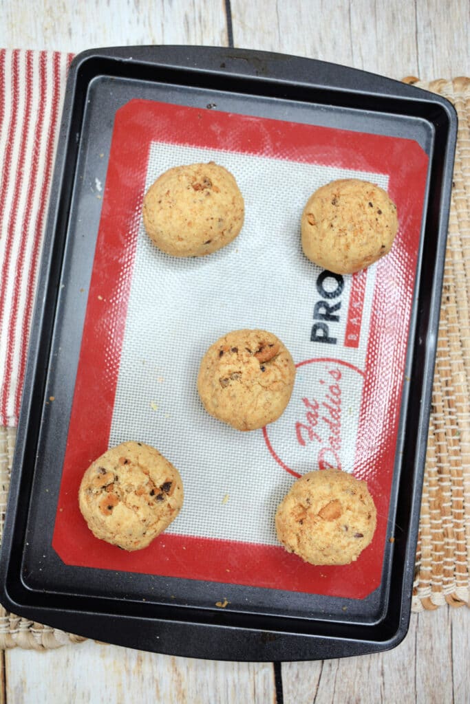 raw cookie dough on a silicone baking mat lined pan