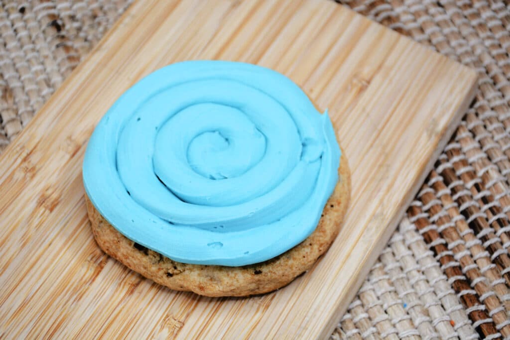 chocolate chip cookie frosted with light blue frosting