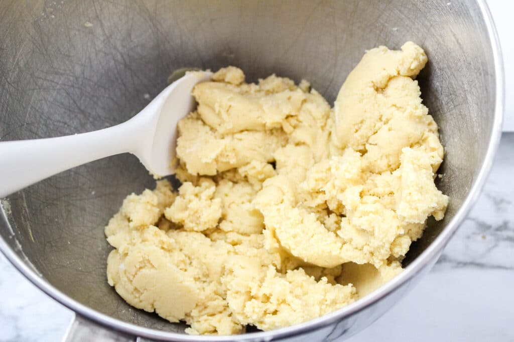 sugar cookie dough in a stainless steel mixing bowl