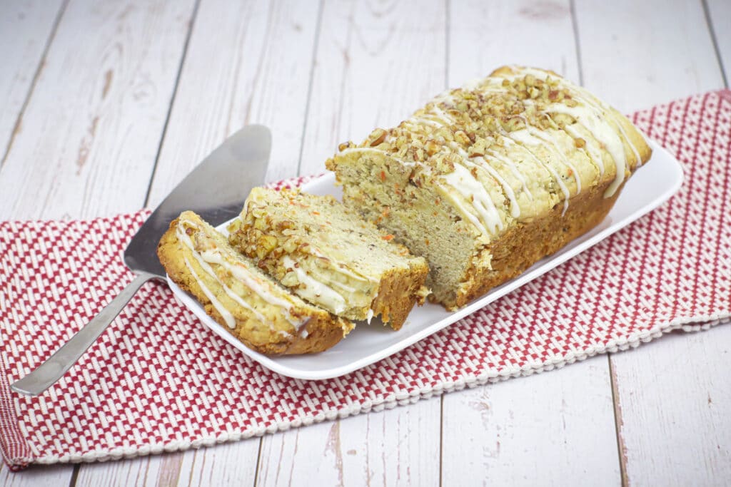 whole carrot cake pound cake with two slices cut