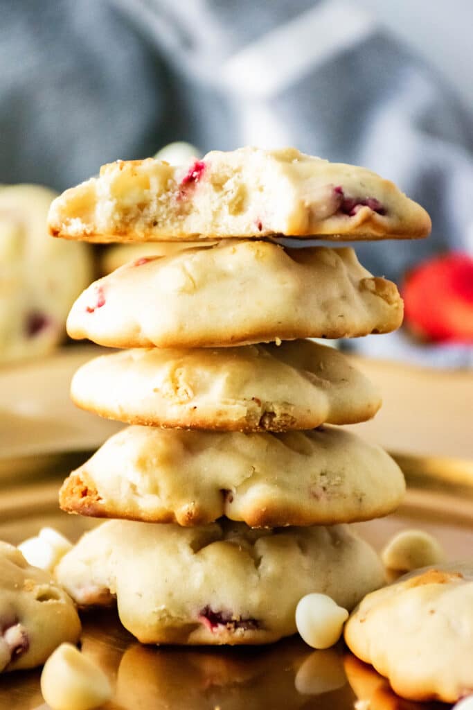 Strawberry Cheesecake Cookies stacked on top of one another on a gold platter