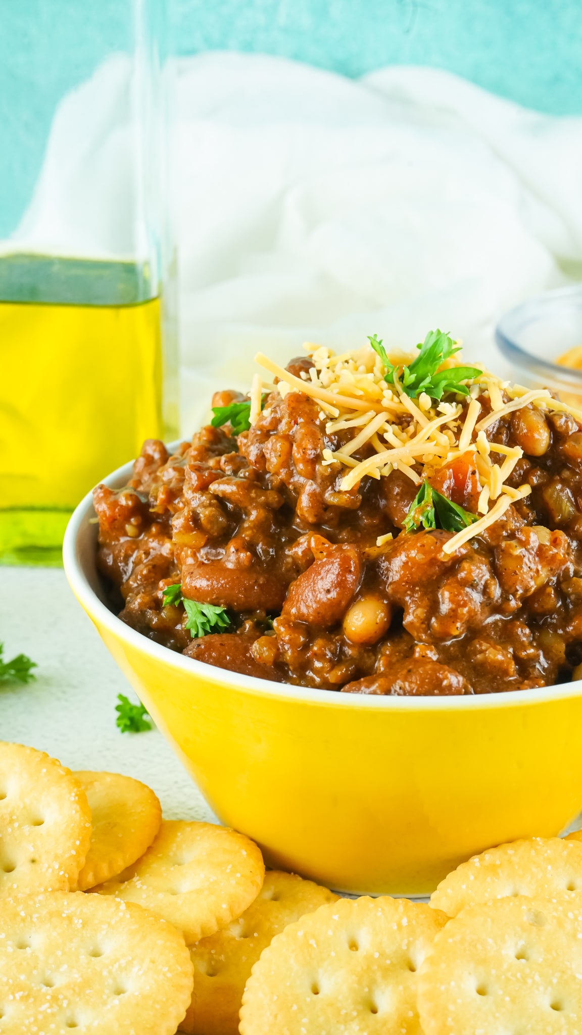 off center image of a yellow bowl filled with chili