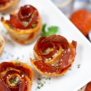 close up air fryer pepperoni roses on a white plate