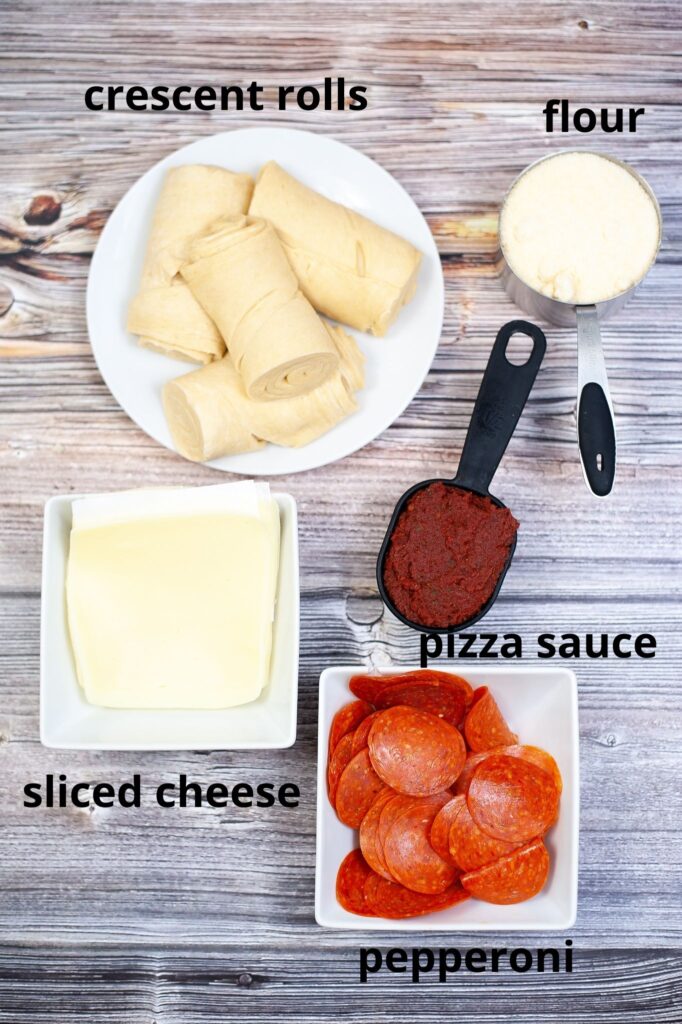 ingredients for air fryer pepperoni roses on a wooden background with labeled with text.