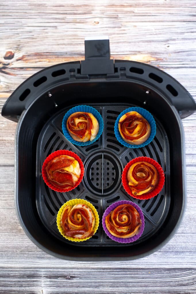 cooked air fryer pepperoni roses in an air fryer basket