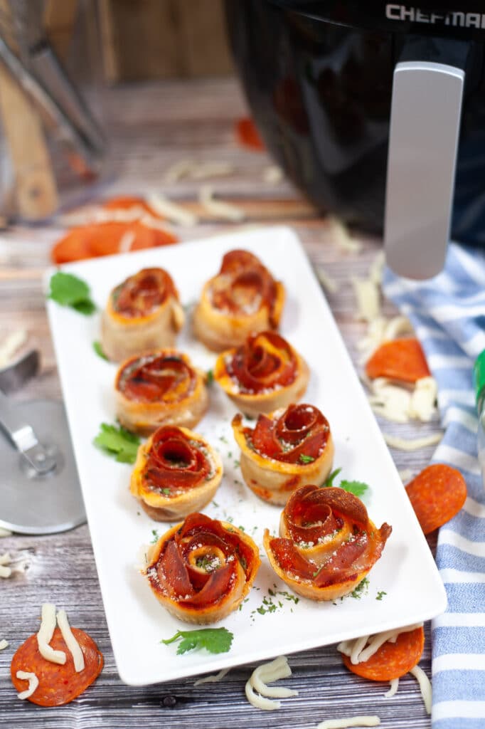 vertical image of air fryer pepperoni roses on a white plate