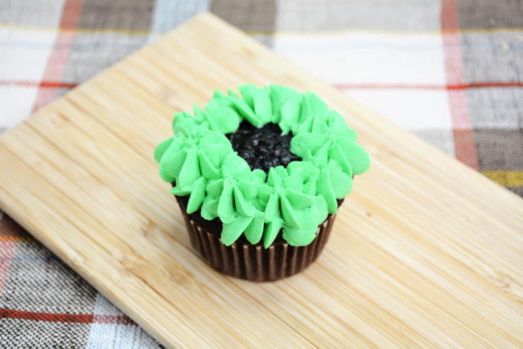 chocolate cupcake topped with green frosting
