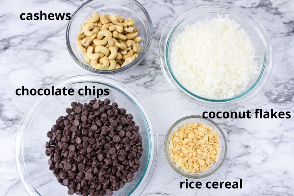 ingredients for coconut clusters on a marble counter labelled with text