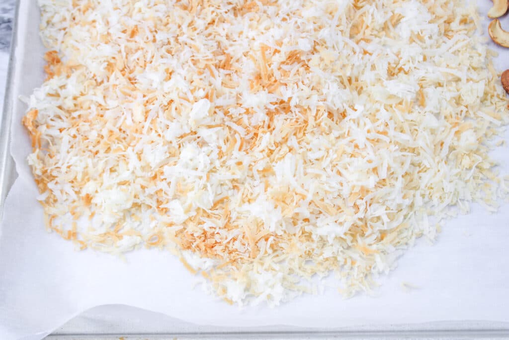 toasted coconut on a parchment lined baking sheet