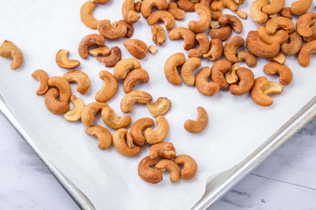 cashews on a parchment lined baking sheet