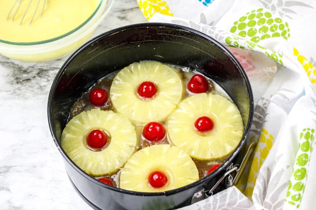 pineapple rings, cherries, brown sugar and melted butter in a springform pan