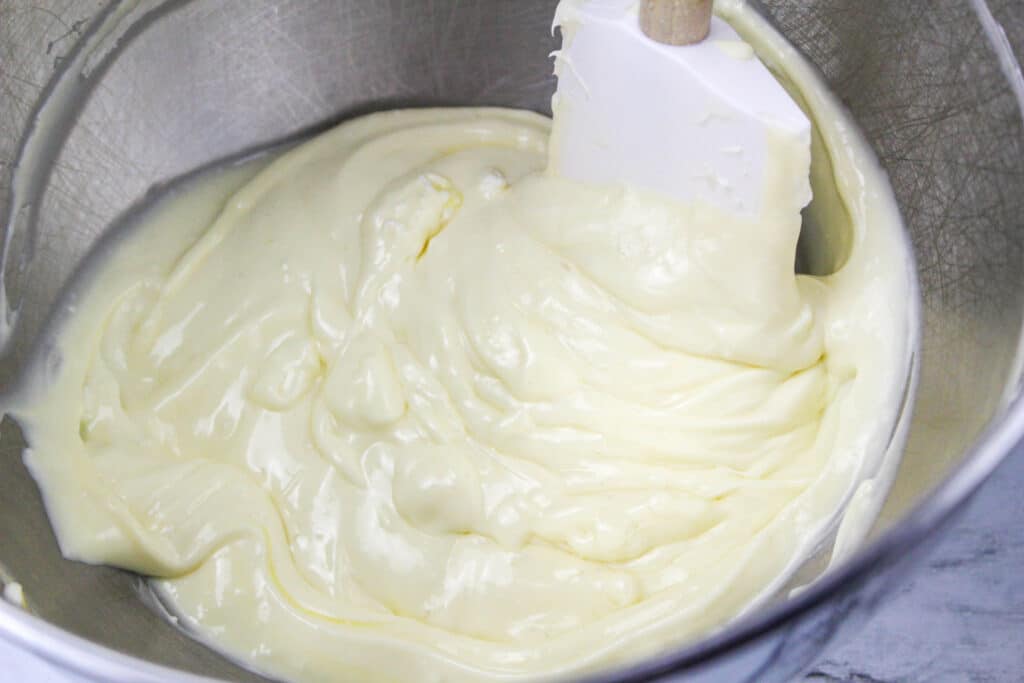 cheesecake filling in a stainless steel mixing bowl