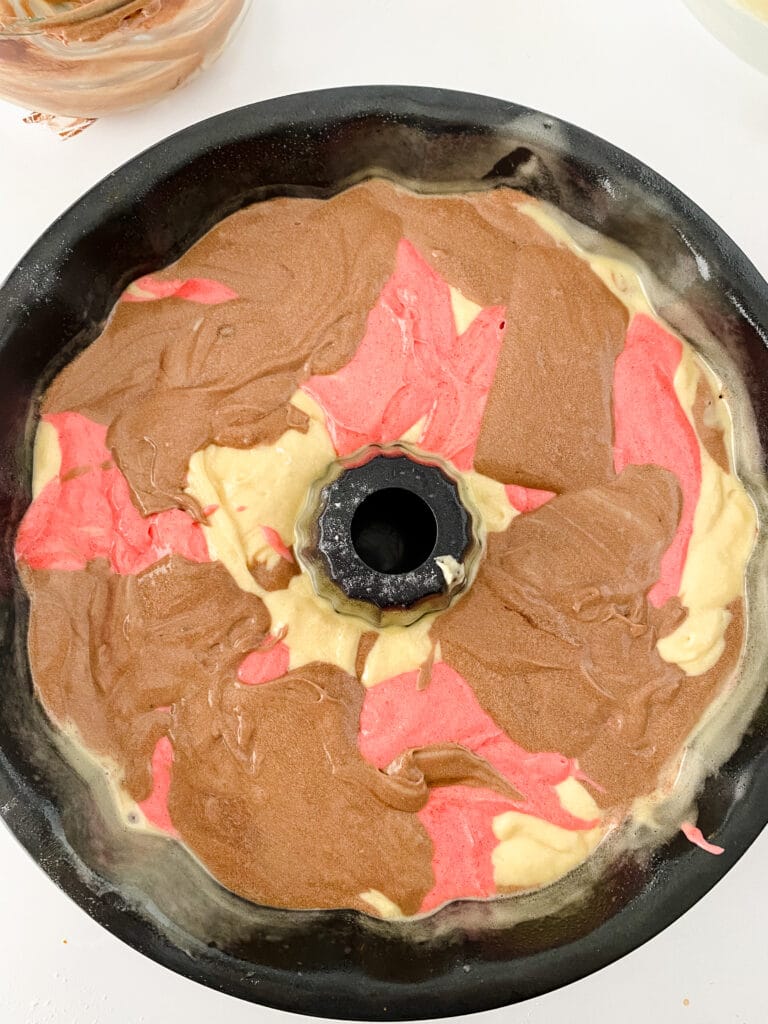 cake batter layered in a bundt can pan