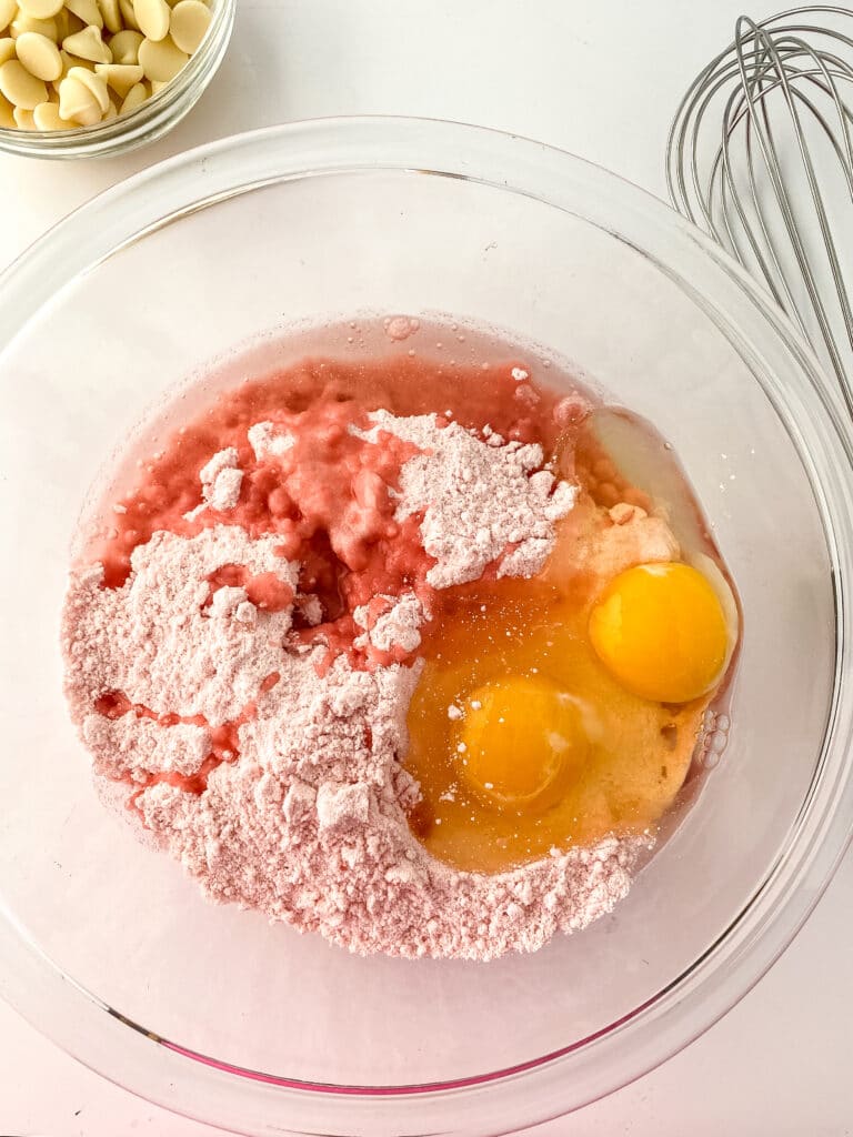strawberry cake mix, oil and eggs in a glass mixing bowl