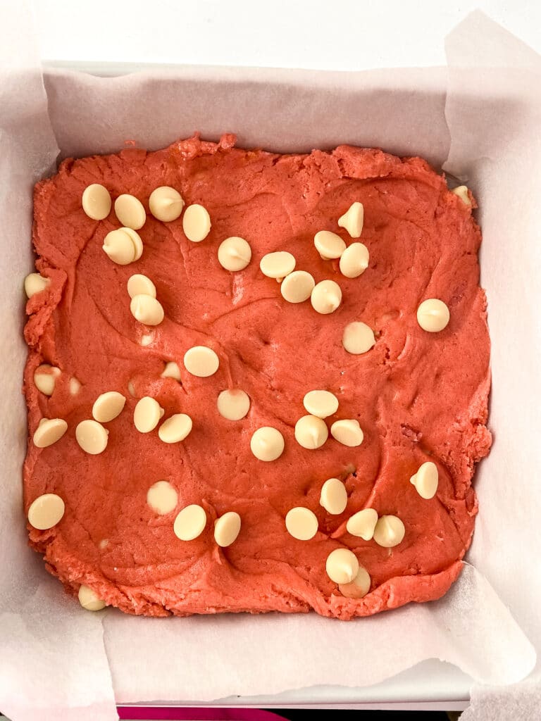 strawberry blondie batter in a square baking dish