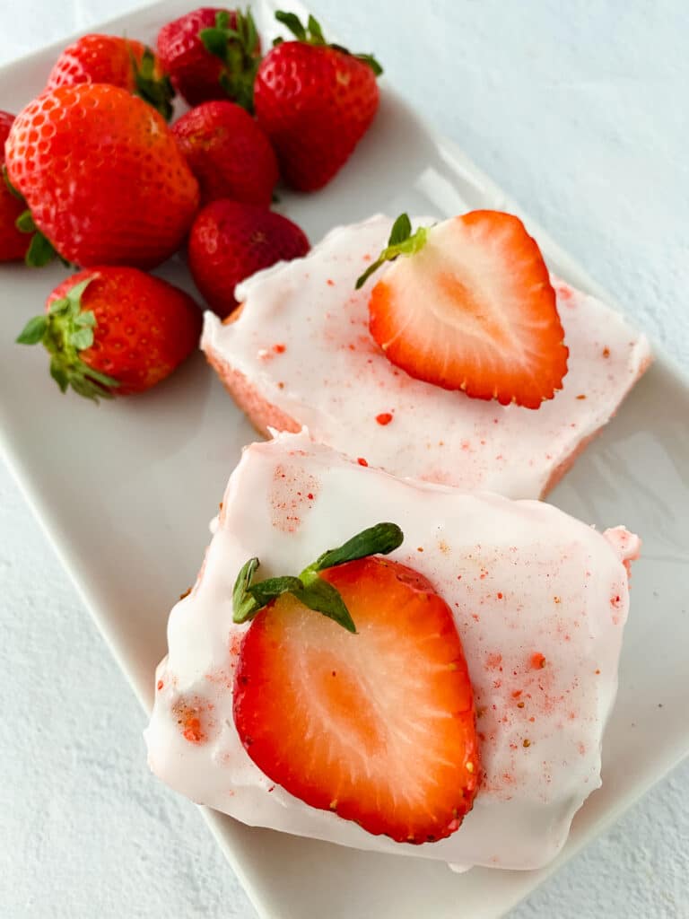 birds eye image of two strawberry blondies on a white platter