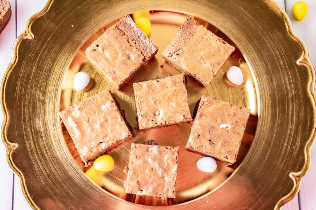 six cadbury mini egg brownies on a gold platter