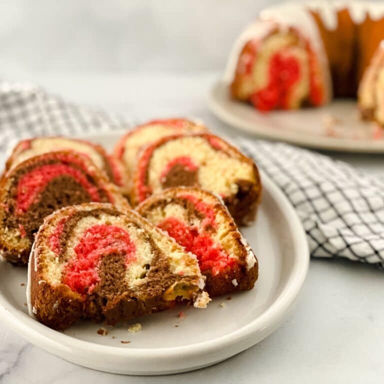 close up of neapolitan bundt cake slices on a white plate